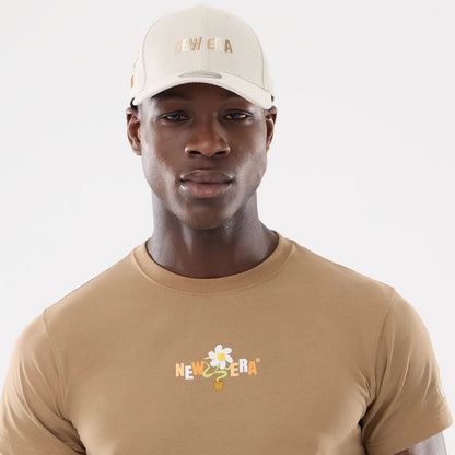 The model is wearing this New Era Earth Day T-Shirt in beige/khaki. 6