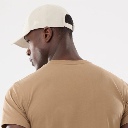 The model is wearing this New Era Earth Day T-Shirt in beige/khaki. 7