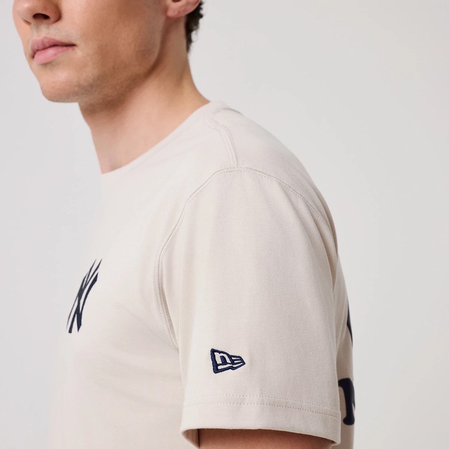 The model is wearing this MLB Banana Graphic New York Yankees T-Shirt in natural. 4