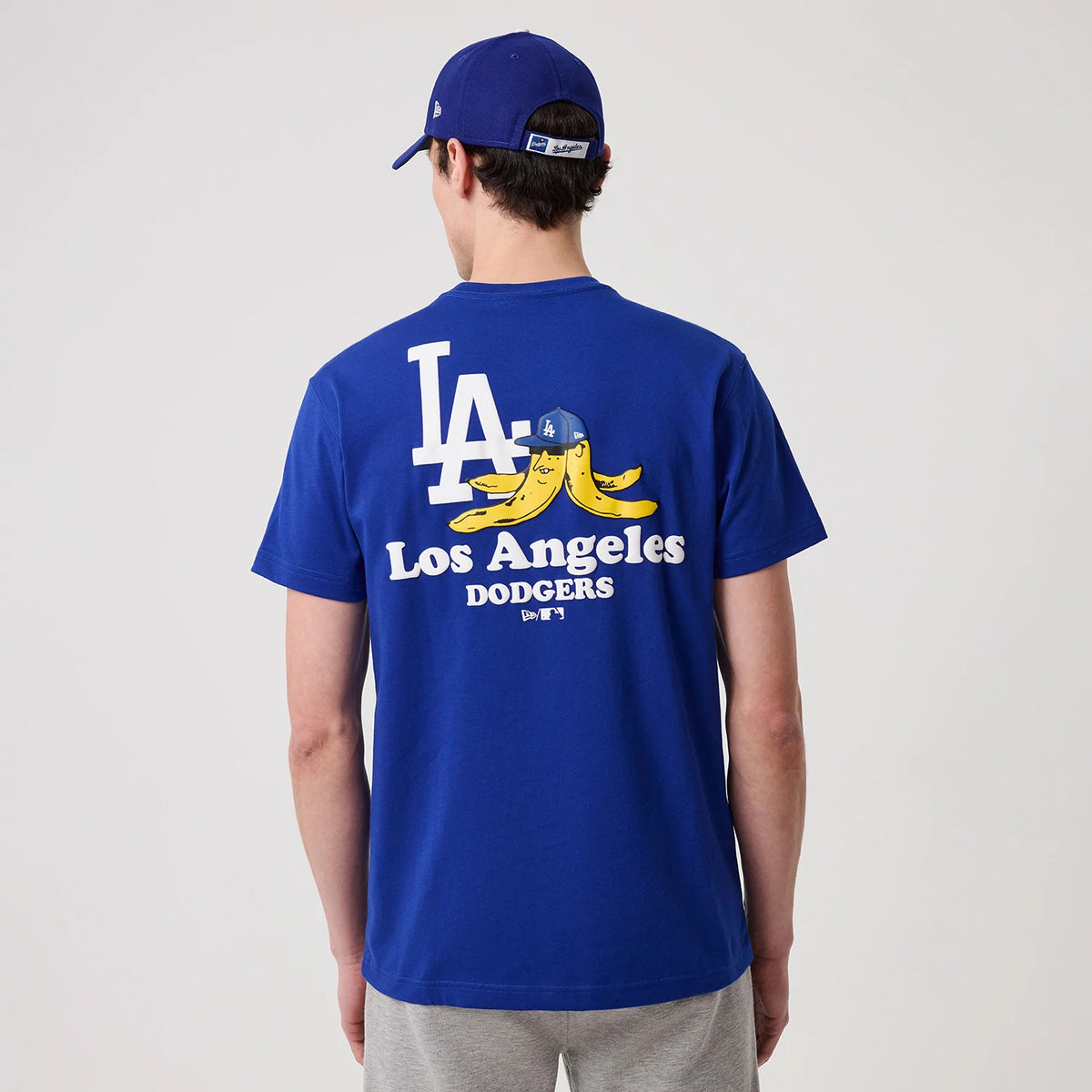 LA Dodgers MLB Banana Graphic Bright Blue T-Shirt, rear view showing the large white LA logo above a playful banana graphic with an LA cap, and the words "Los Angeles Dodgers" printed below on a bright blue background.