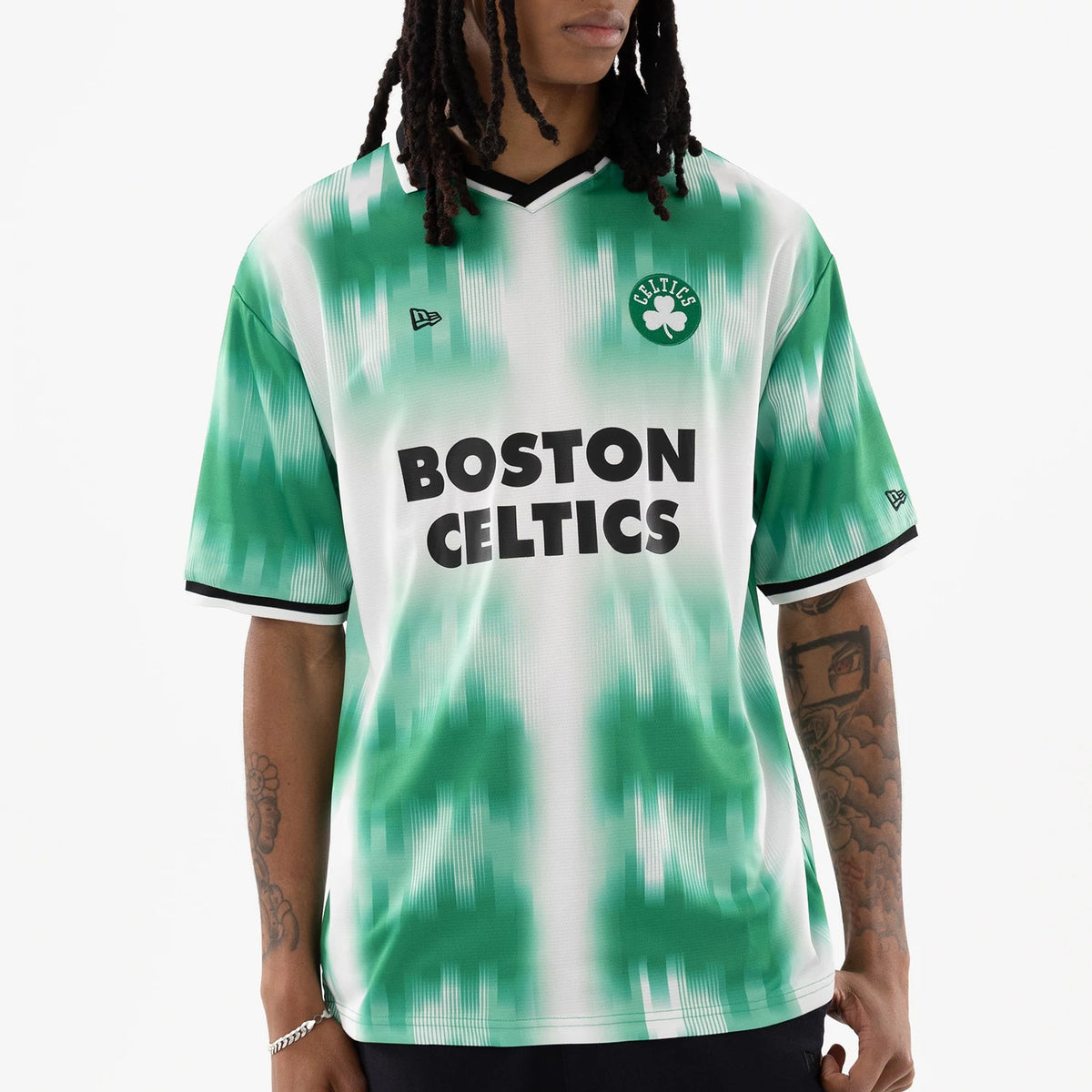Boston Celtics NBA Green Soccer Jersey, front view on a model showing a green and white gradient pattern with black Boston Celtics lettering, a Celtics clover emblem on the left chest, and New Era logo on the right chest.