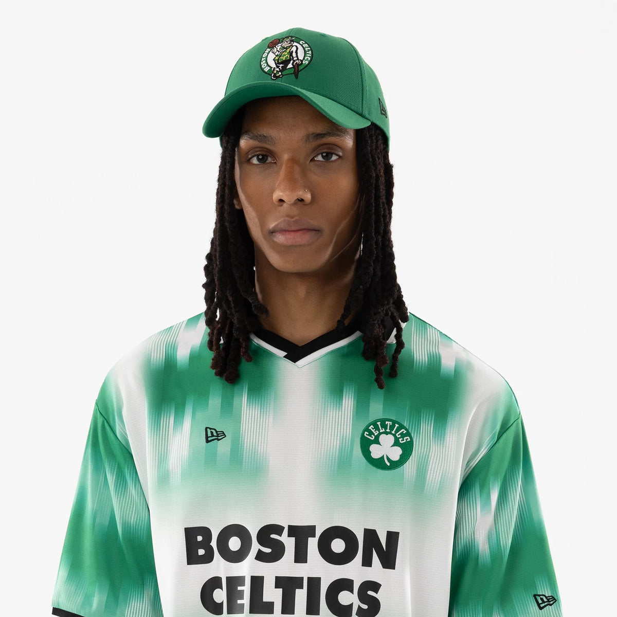 Boston Celtics NBA Green Soccer Jersey, front view on a model wearing a matching green cap with a raised Boston Celtics logo on the front panel and New Era flag logo on the left side.