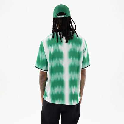 The model is wearing this NBA Boston Celtics Soccer Jersey in green. 2