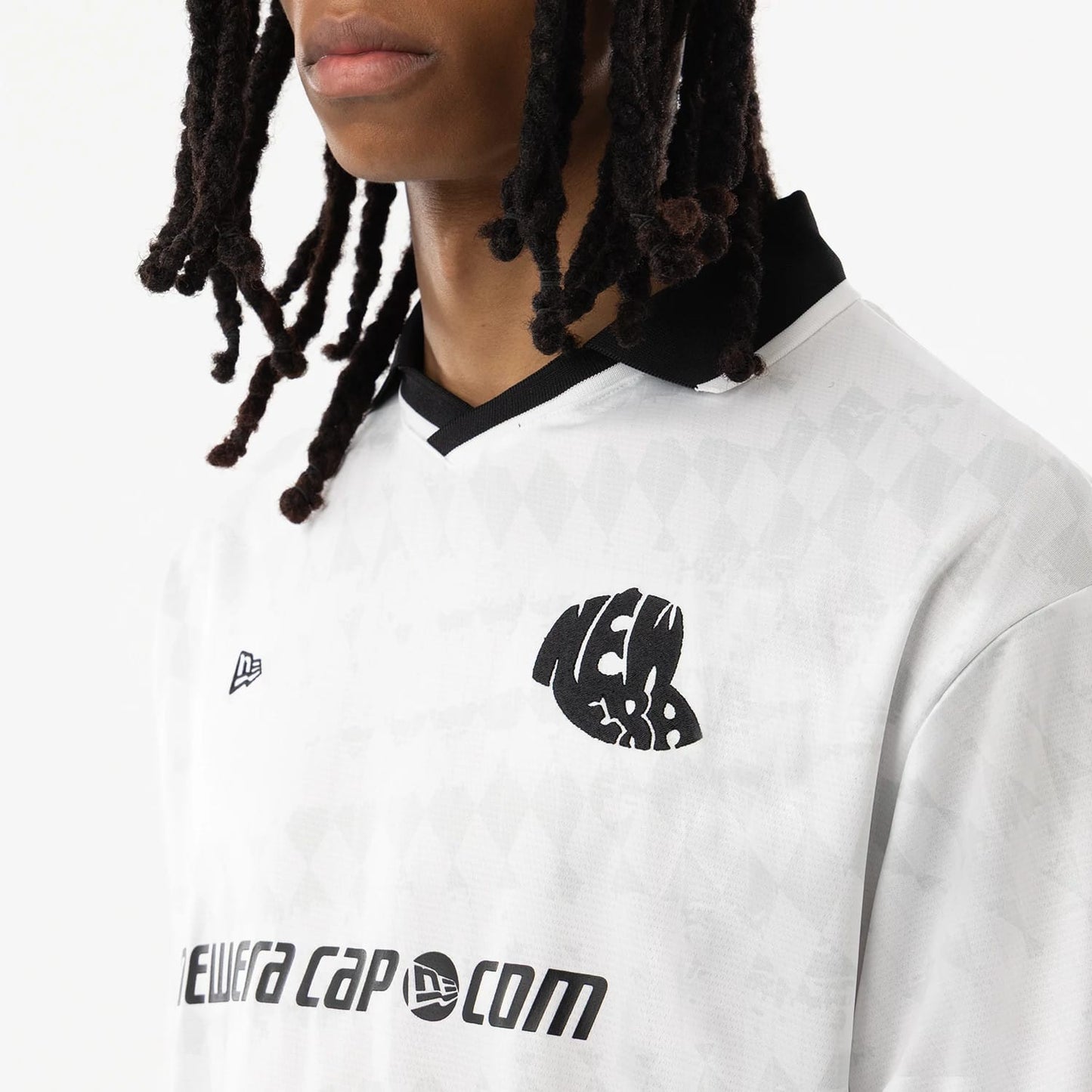 The model is wearing this New Era Soccer Jersey in white. 4