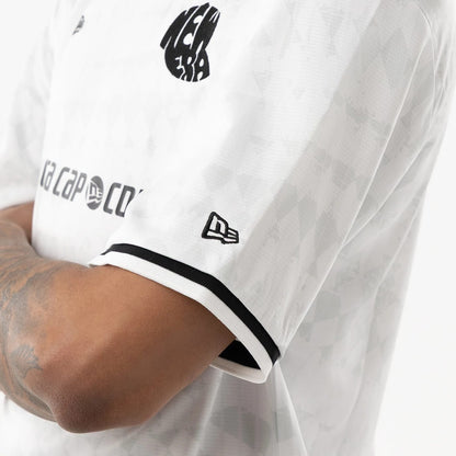 The model is wearing this New Era Soccer Jersey in white. 5
