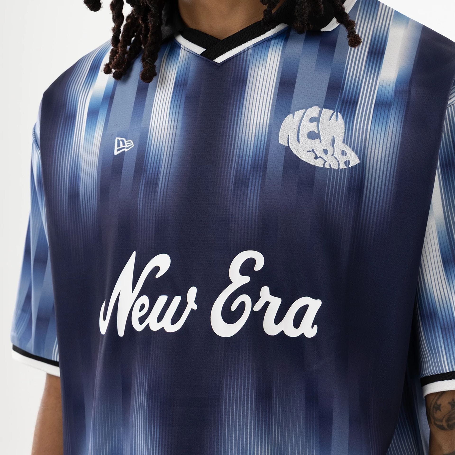 The model is wearing this New Era Soccer Jersey in navy. 5