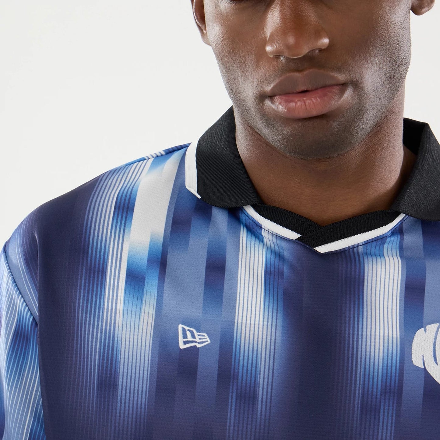 The model is wearing this New Era Soccer Jersey in navy. 5