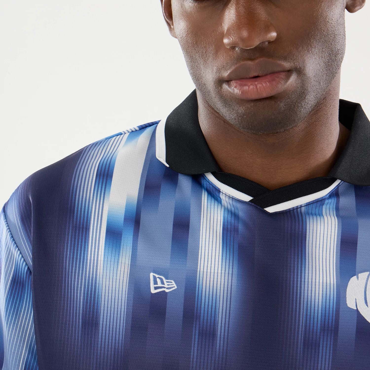 The model is wearing this New Era Soccer Jersey in navy. 5