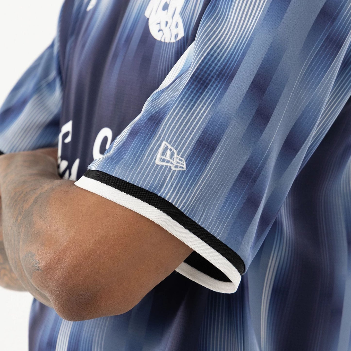 The model is wearing this New Era Soccer Jersey in navy. 4