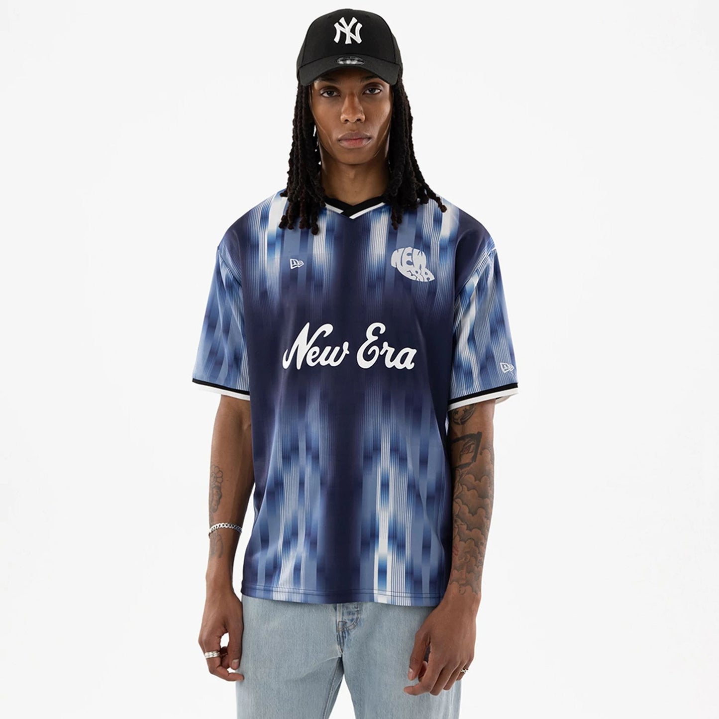 The model is wearing this New Era Soccer Jersey in navy. 1