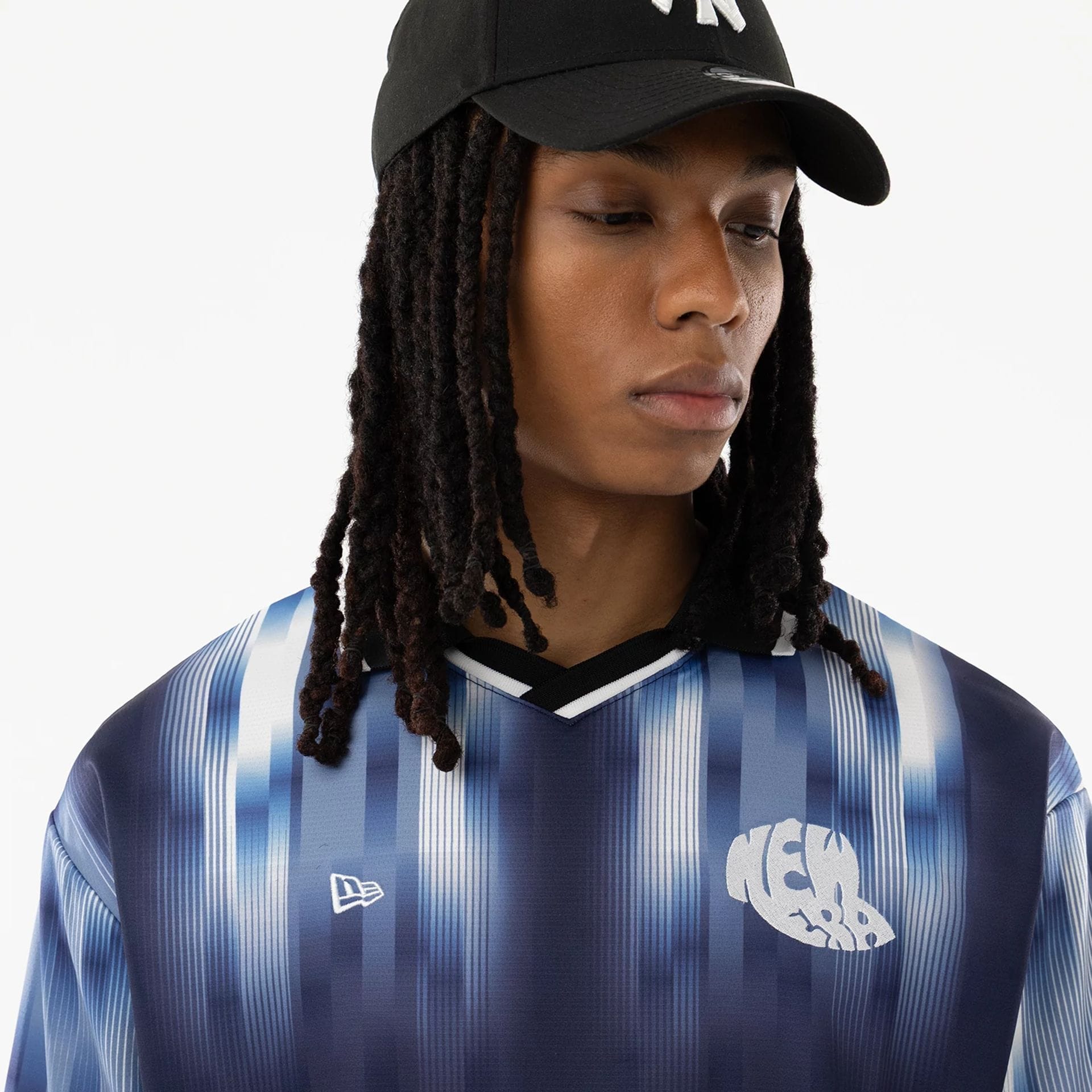 The model is wearing this New Era Soccer Jersey in navy. 7