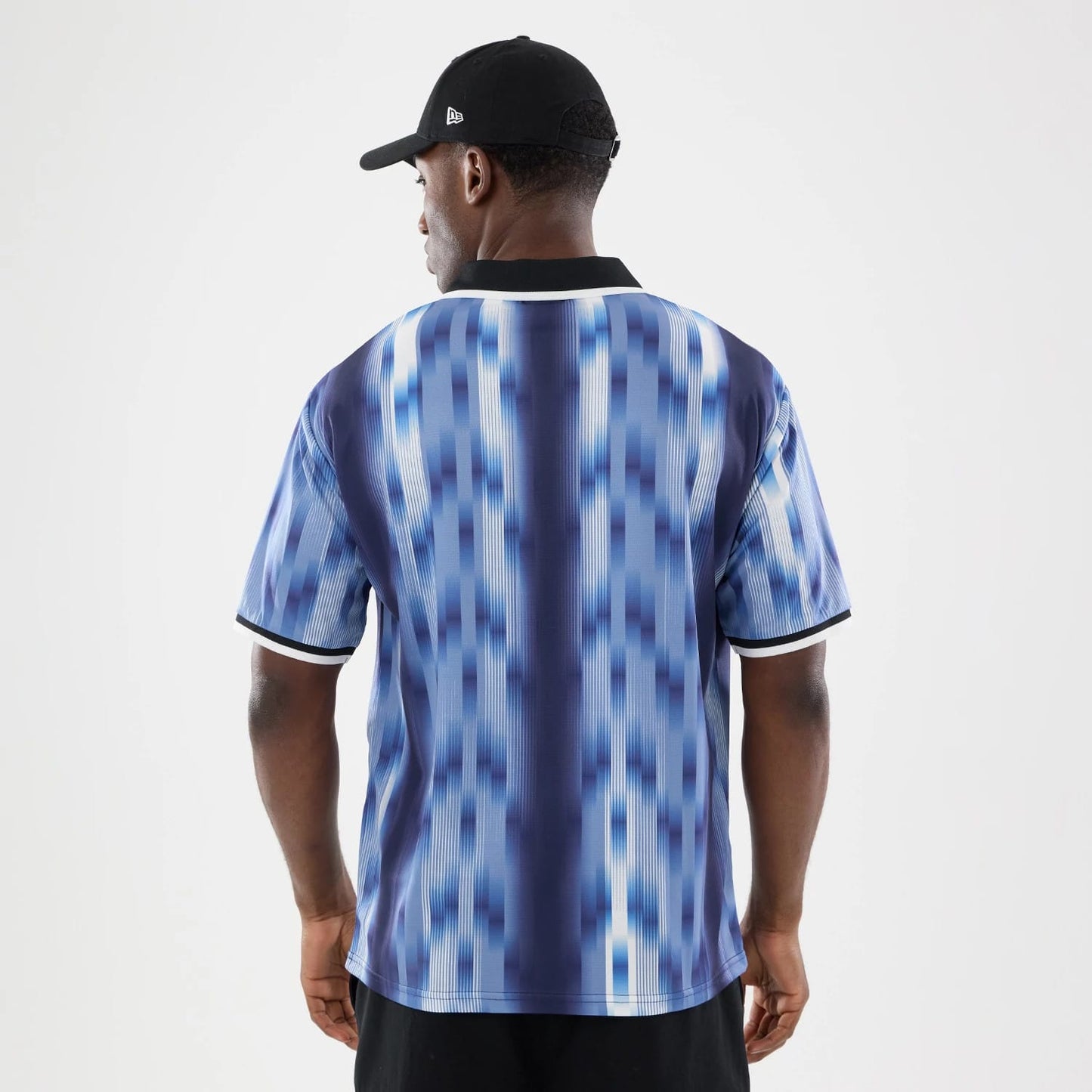 The model is wearing this New Era Soccer Jersey in navy. 2