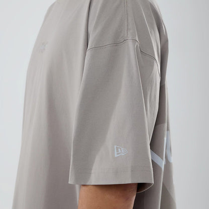 The model is wearing this New Era NEC Logo Oversized T-Shirt in Beige. 6