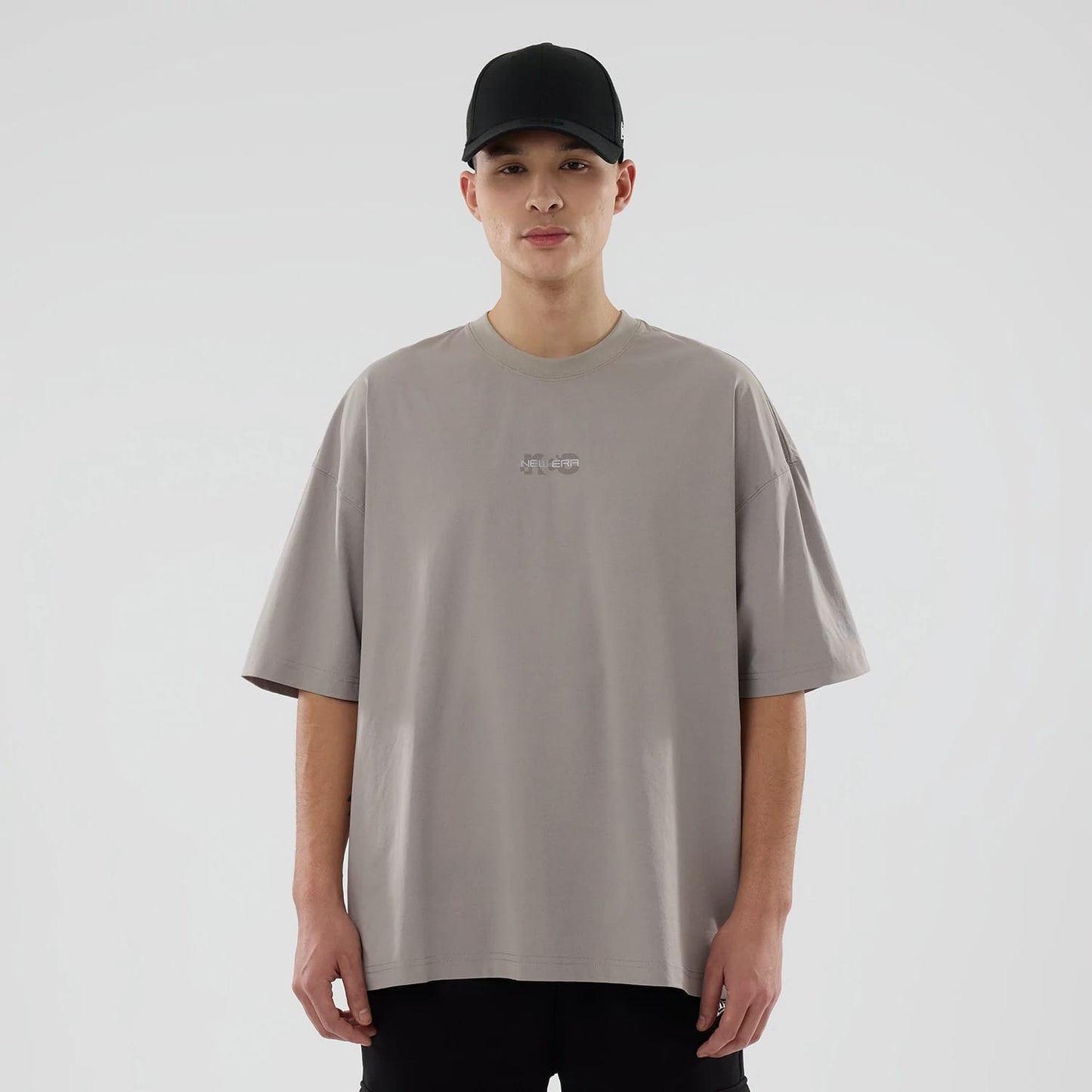 The model is wearing this New Era NEC Logo Oversized T-Shirt in Beige. 1