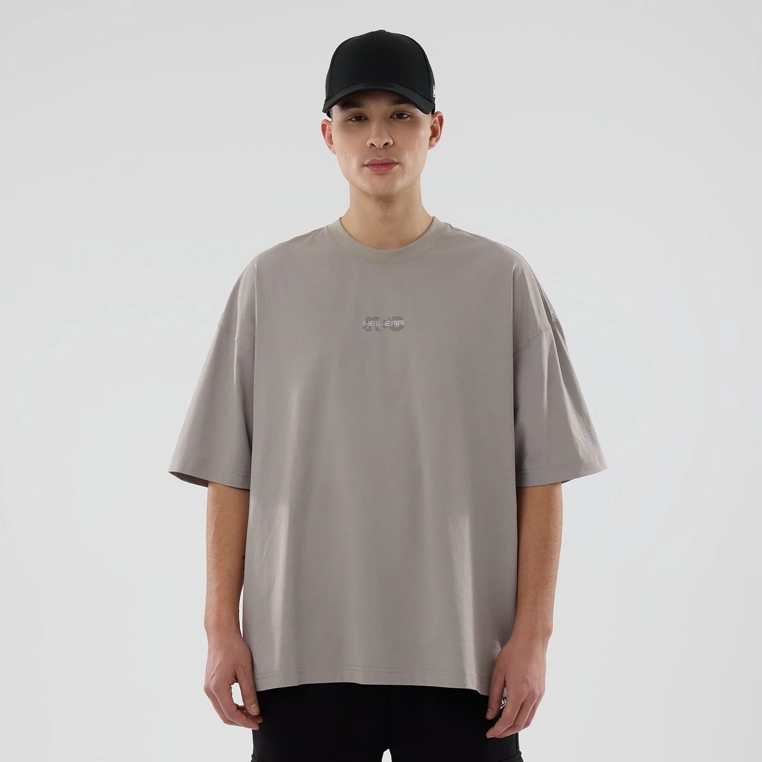 The model is wearing this New Era NEC Logo Oversized T-Shirt in Beige. 1