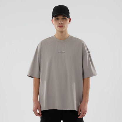 The model is wearing this New Era NEC Logo Oversized T-Shirt in Beige. 1