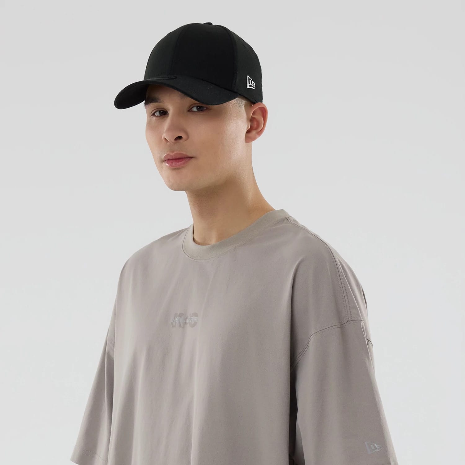 The model is wearing this New Era NEC Logo Oversized T-Shirt in Beige. 7