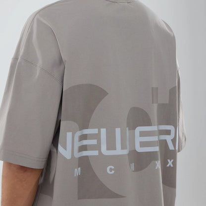 The model is wearing this New Era NEC Logo Oversized T-Shirt in Beige. 4