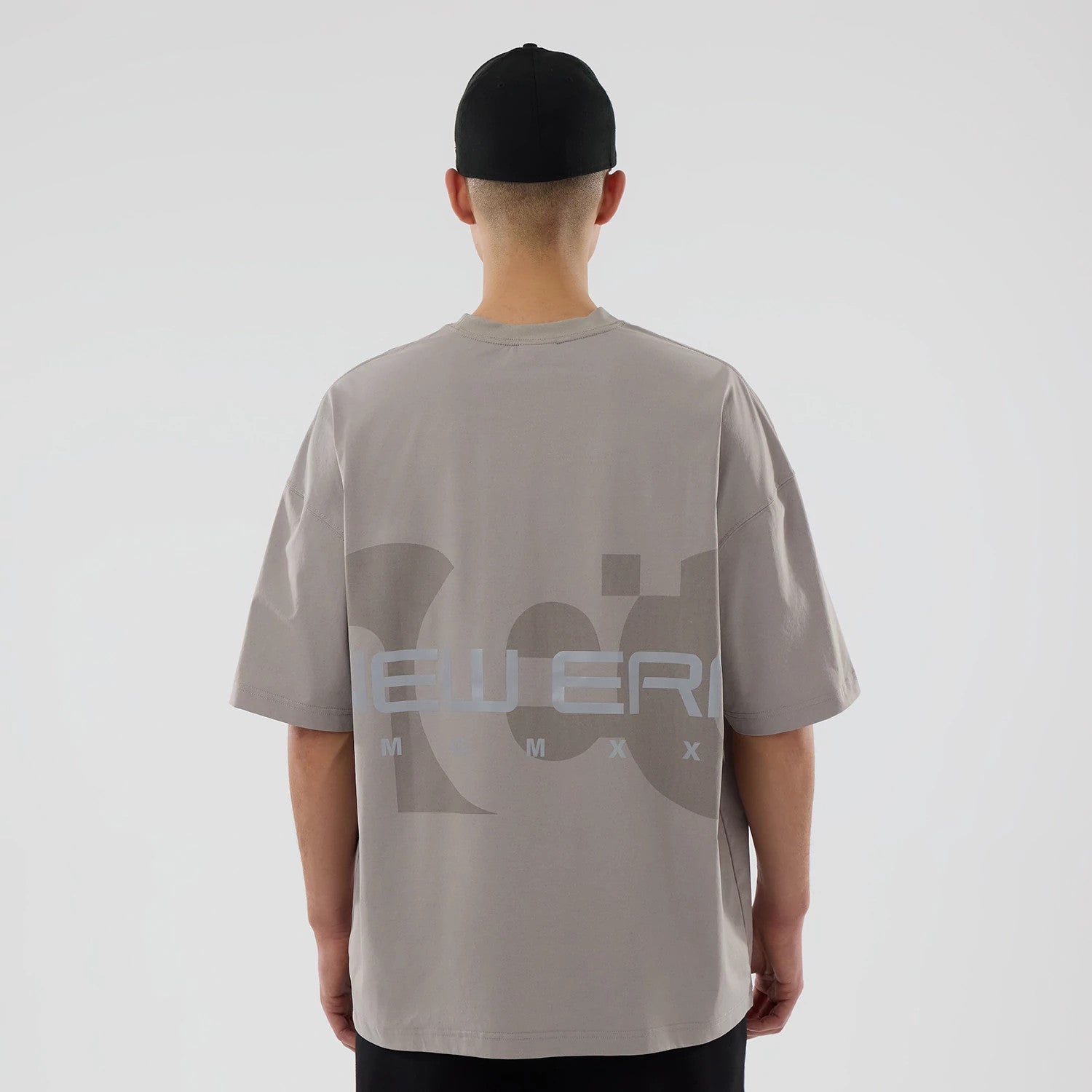 The model is wearing this New Era NEC Logo Oversized T-Shirt in Beige. 2