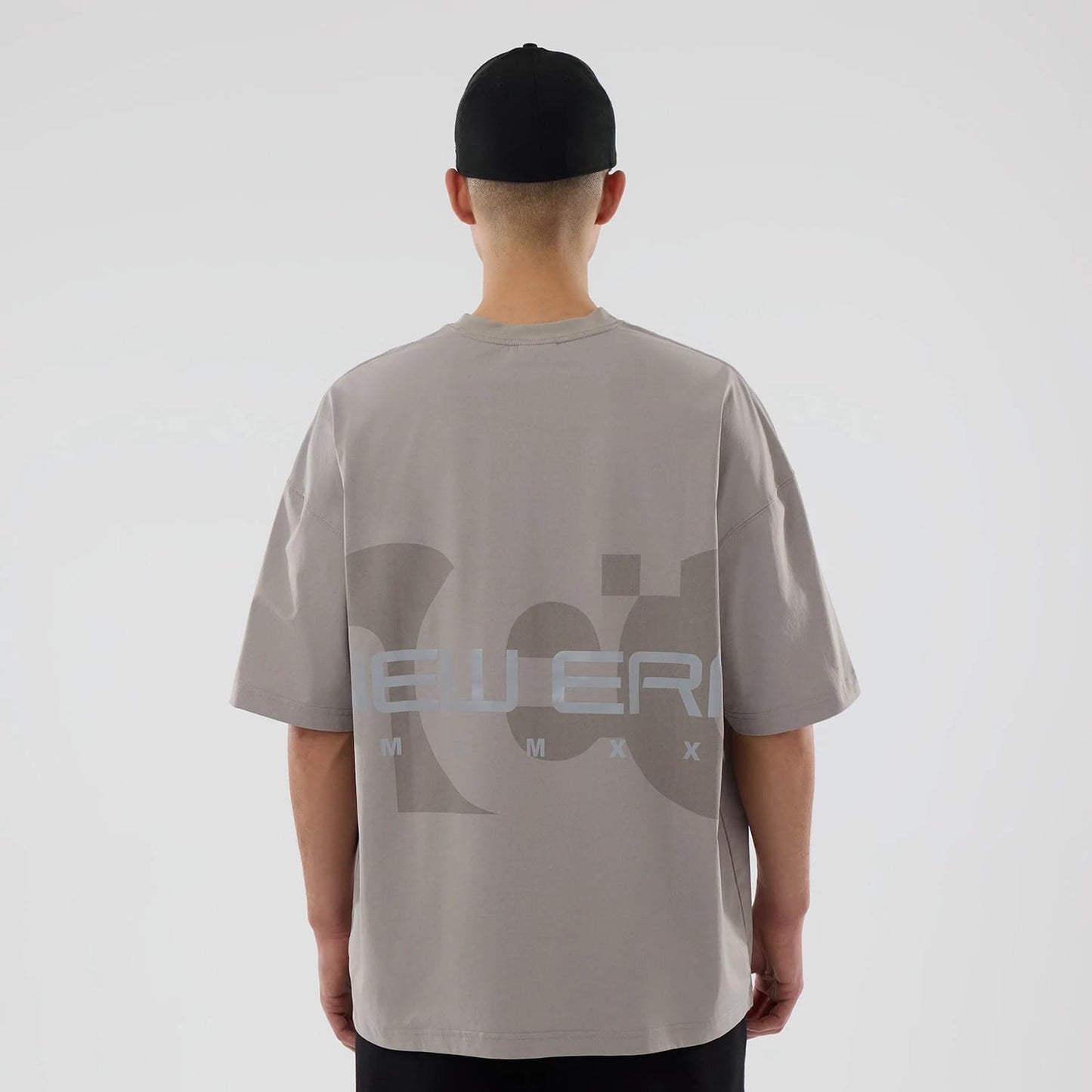 The model is wearing this New Era NEC Logo Oversized T-Shirt in Beige. 2