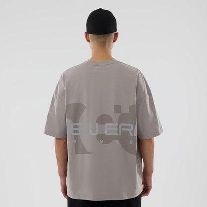 The model is wearing this New Era NEC Logo Oversized T-Shirt in Beige. 2