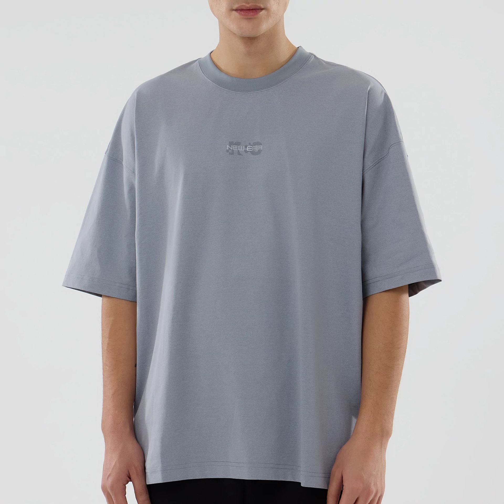 The model is wearing this New Era NEC Logo Oversized T-Shirt in grey. 3