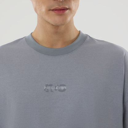 The model is wearing this New Era NEC Logo Oversized T-Shirt in grey. 4