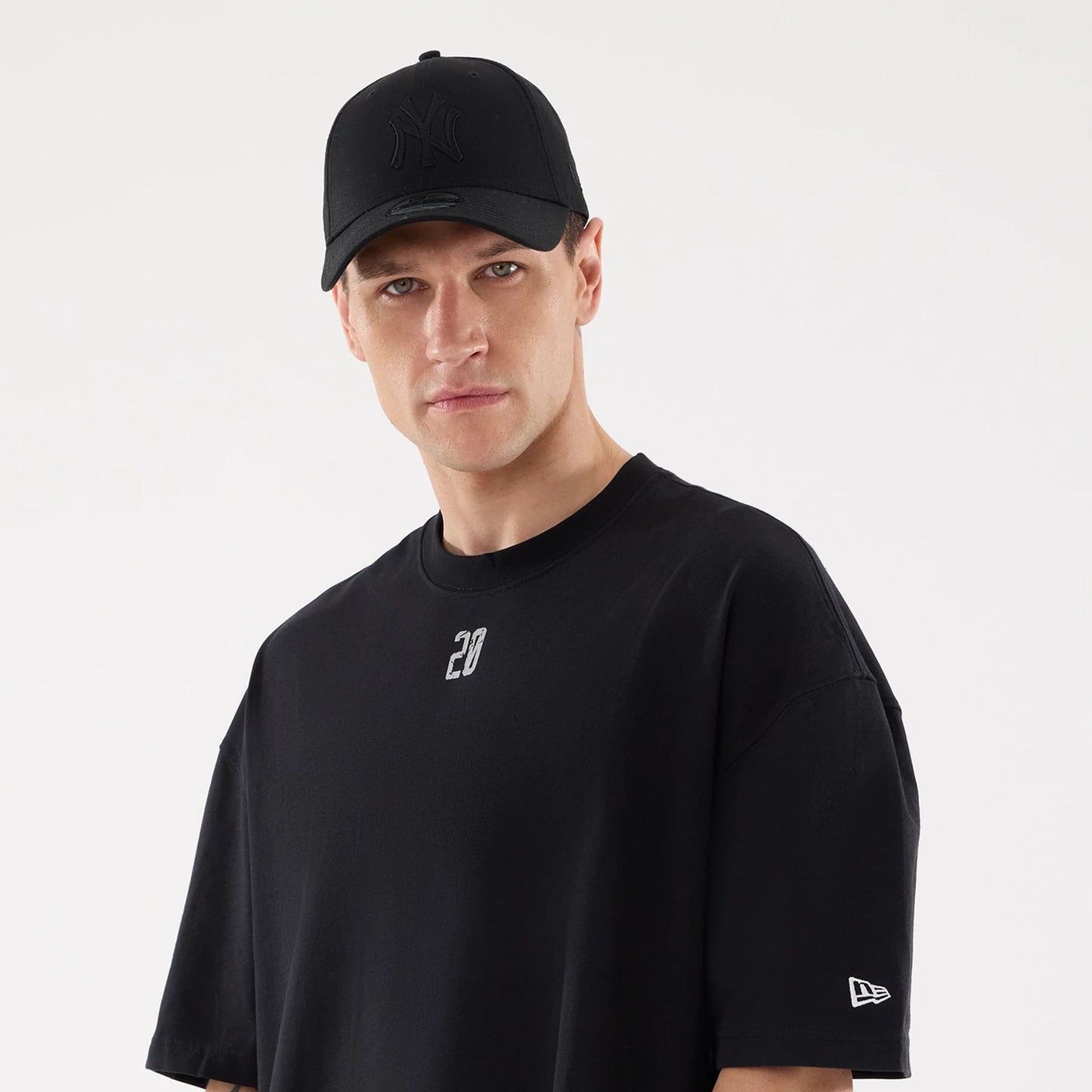 The model is wearing this New Era Street Archived City Oversized T-Shirt in black. 6