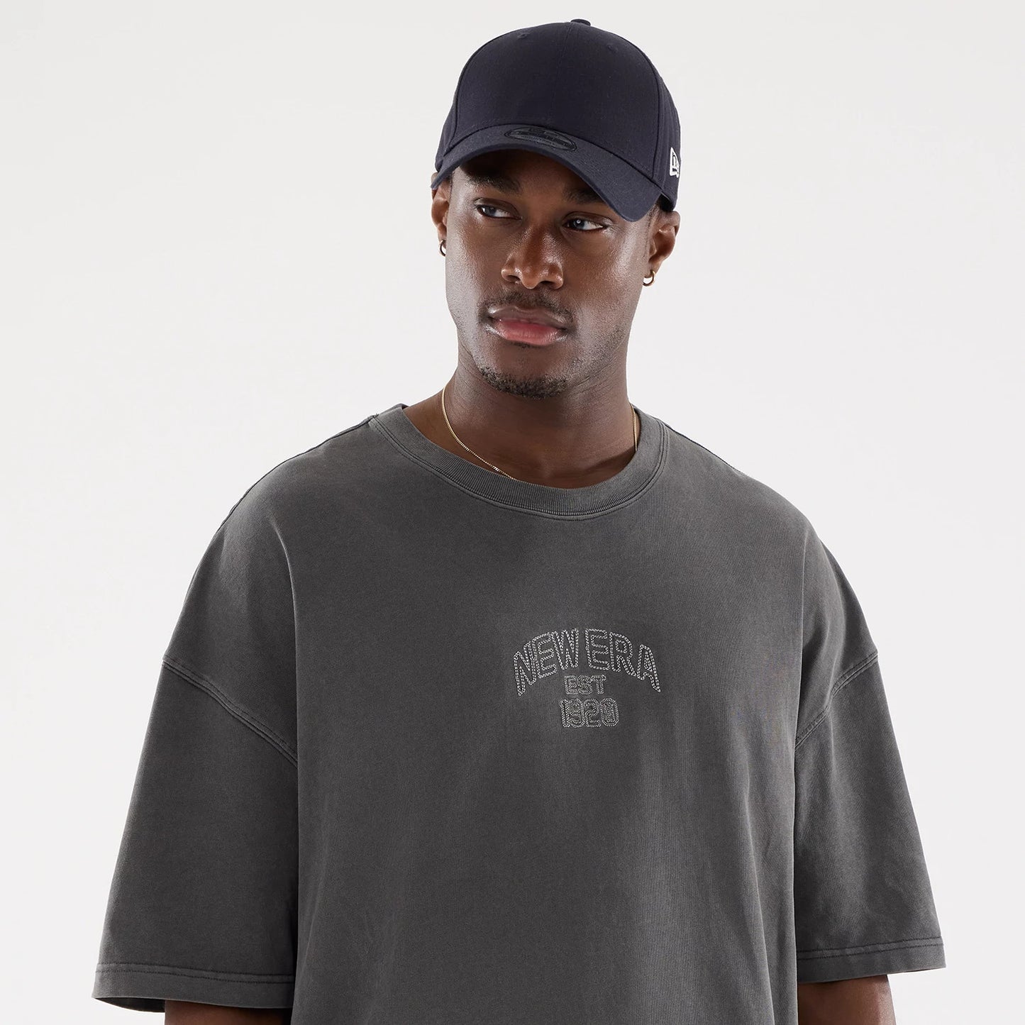 The model is wearing this New Era Street Archived Oversized T-Shirt in black. 6
