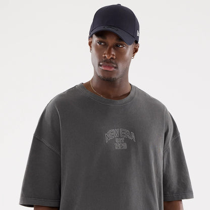 The model is wearing this New Era Street Archived Oversized T-Shirt in black. 6