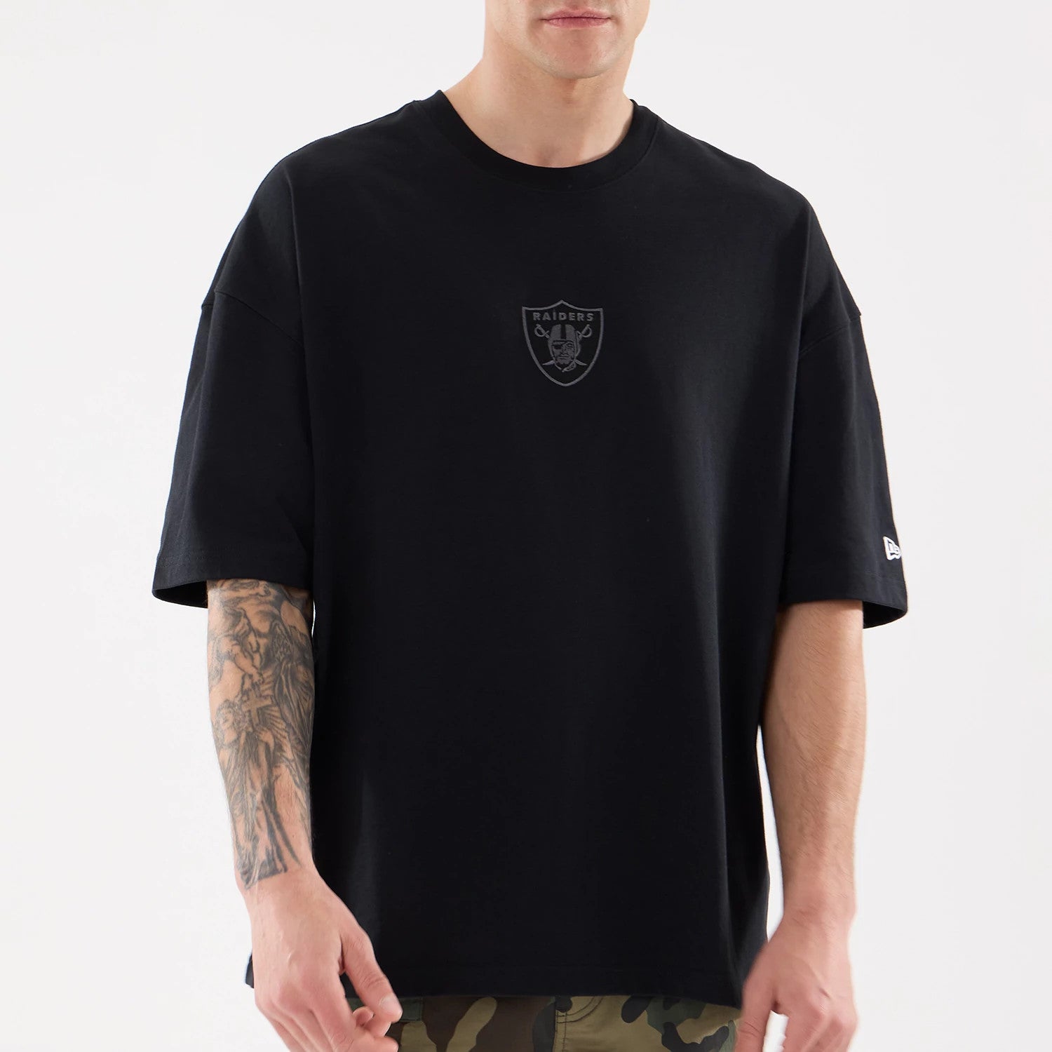 The model is wearing this NFL Raiders Wear Las Vegas Raiders Oversized T-Shirt in black. 3