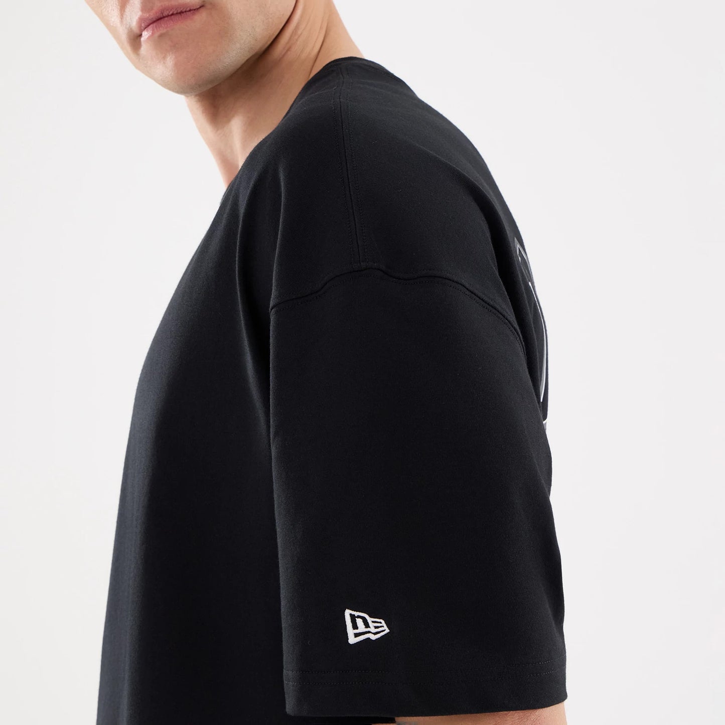 The model is wearing this NFL Raiders Wear Las Vegas Raiders Oversized T-Shirt in black. 5