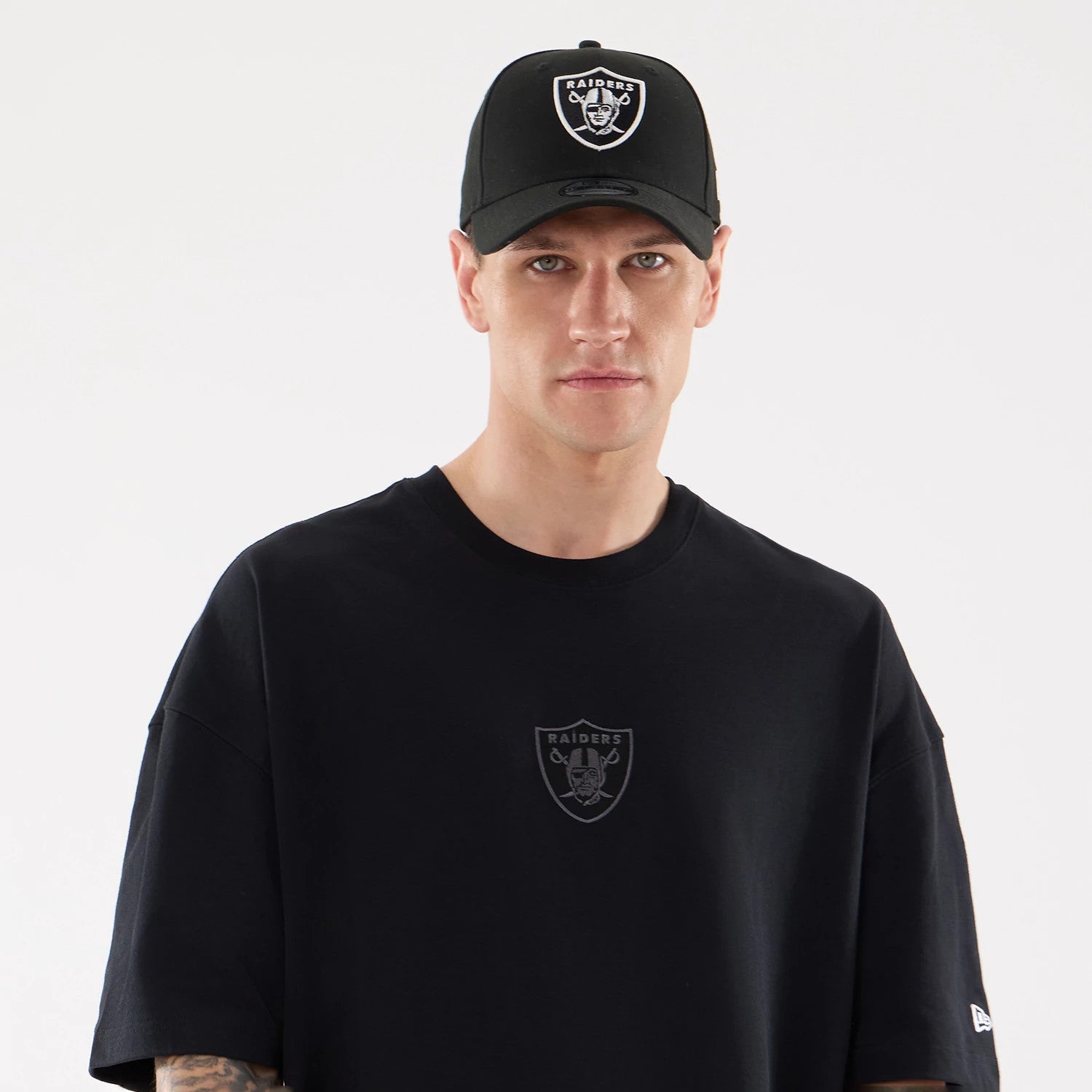 The model is wearing this NFL Raiders Wear Las Vegas Raiders Oversized T-Shirt in black. 6