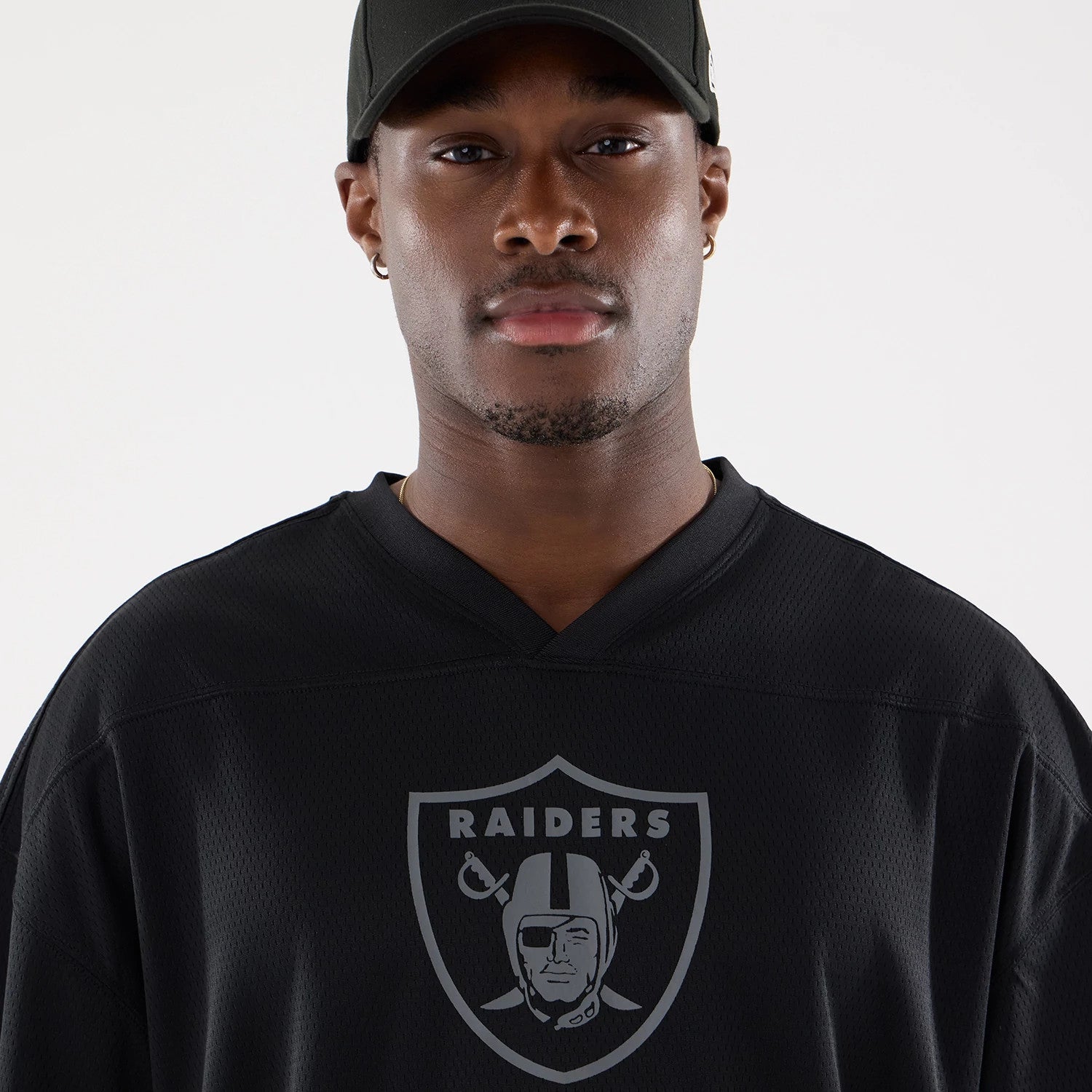 The model is wearing this NFL Raiders Wear Black Las Vegas Raiders Mesh Oversized T-Shirt in black. 4