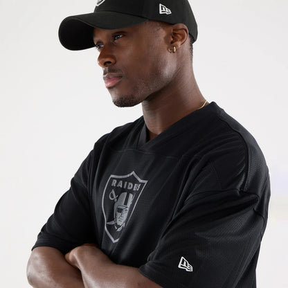 The model is wearing this NFL Raiders Wear Black Las Vegas Raiders Mesh Oversized T-Shirt in black. 5