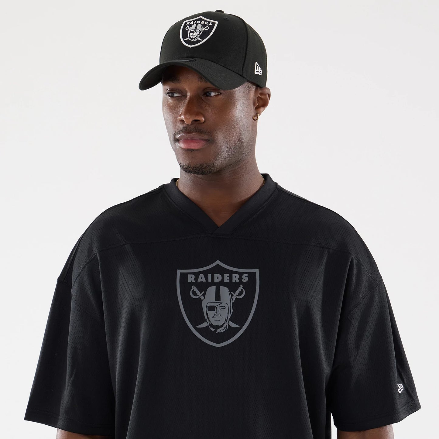 The model is wearing this NFL Raiders Wear Black Las Vegas Raiders Mesh Oversized T-Shirt in black. 6