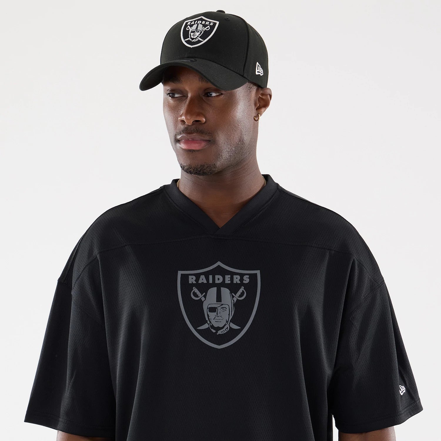 The model is wearing this NFL Raiders Wear Black Las Vegas Raiders Mesh Oversized T-Shirt in black. 6