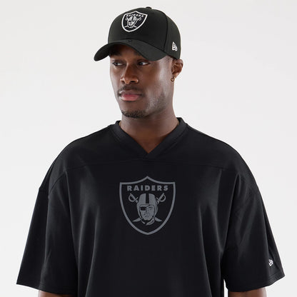 The model is wearing this NFL Raiders Wear Black Las Vegas Raiders Mesh Oversized T-Shirt in black. 6