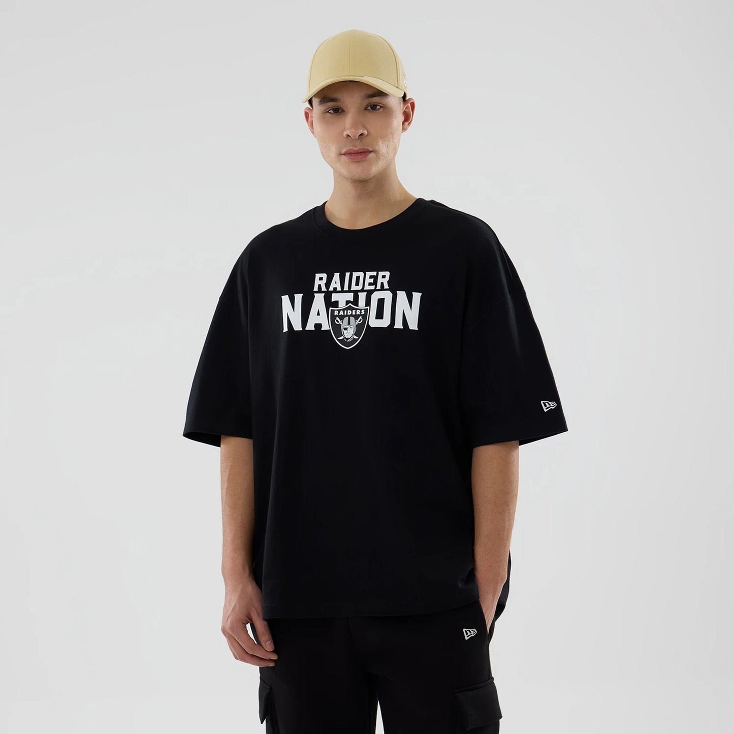 The model is wearing this NFL Rivalry Las Vegas Raiders Oversized T-Shirt in black. 1