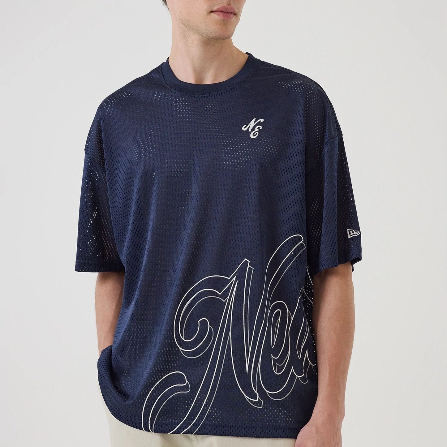 The model is wearing this New Era Mix League Oversized Mesh T-Shirt in blue. 6