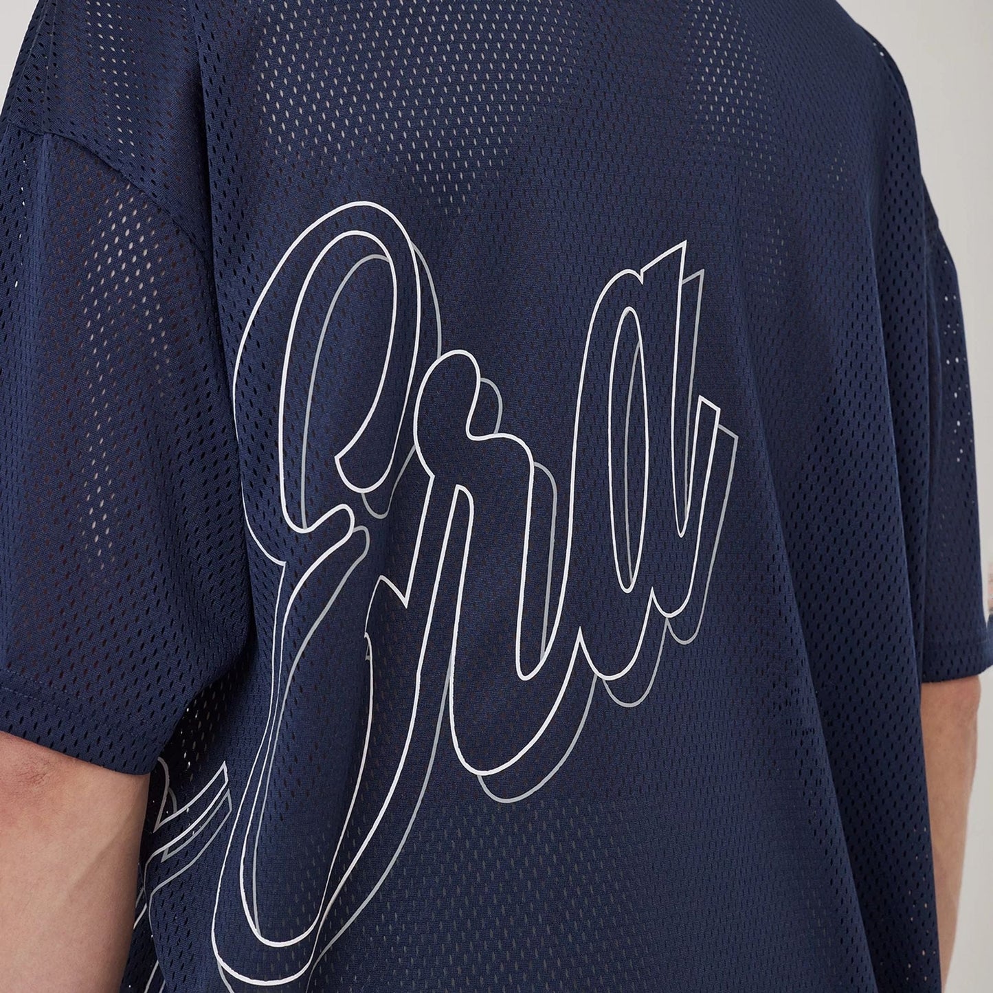 The model is wearing this New Era Mix League Oversized Mesh T-Shirt in blue. 3