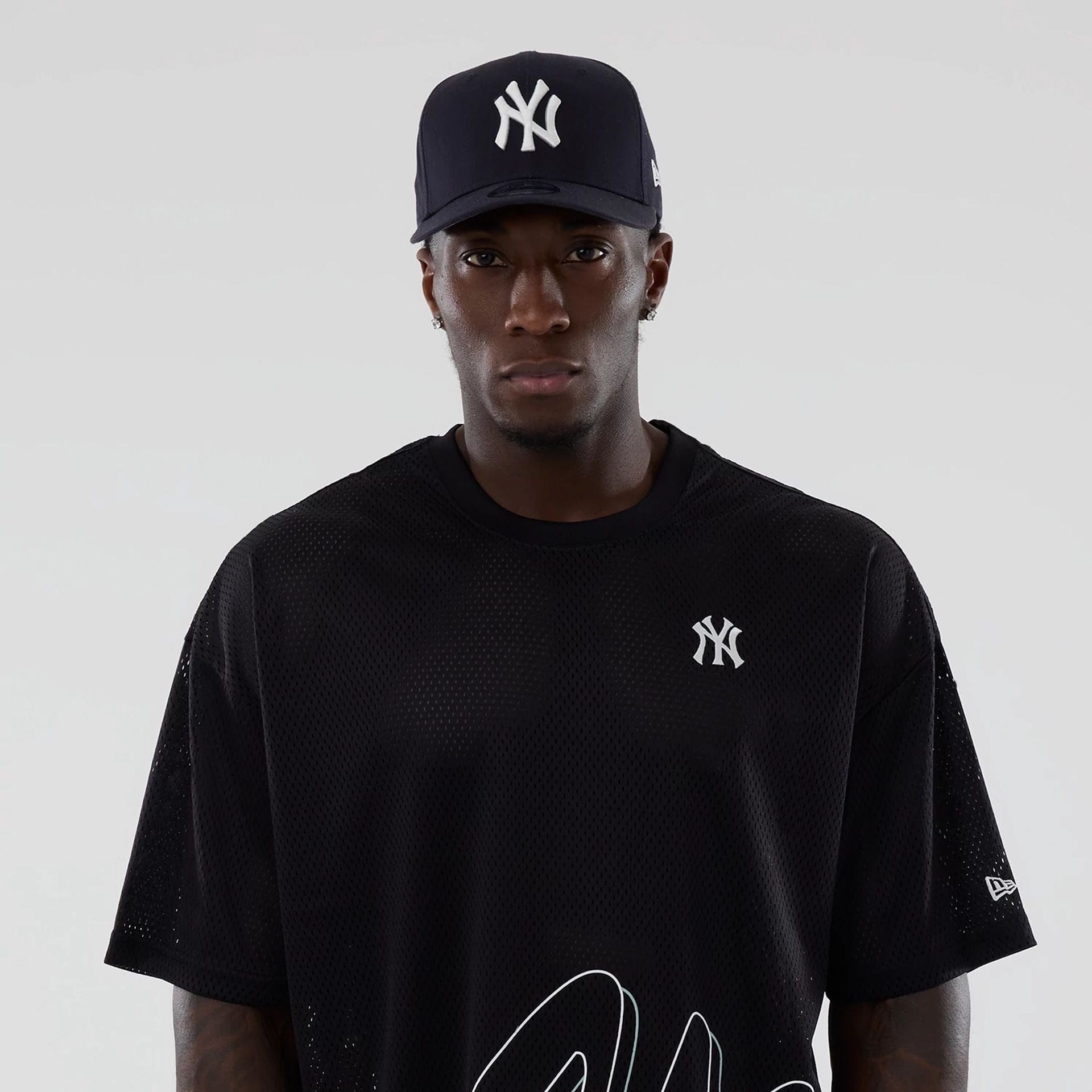 The model is wearing this MLB Mix League New York Yankees Oversized Mesh T-Shirt in black. 7