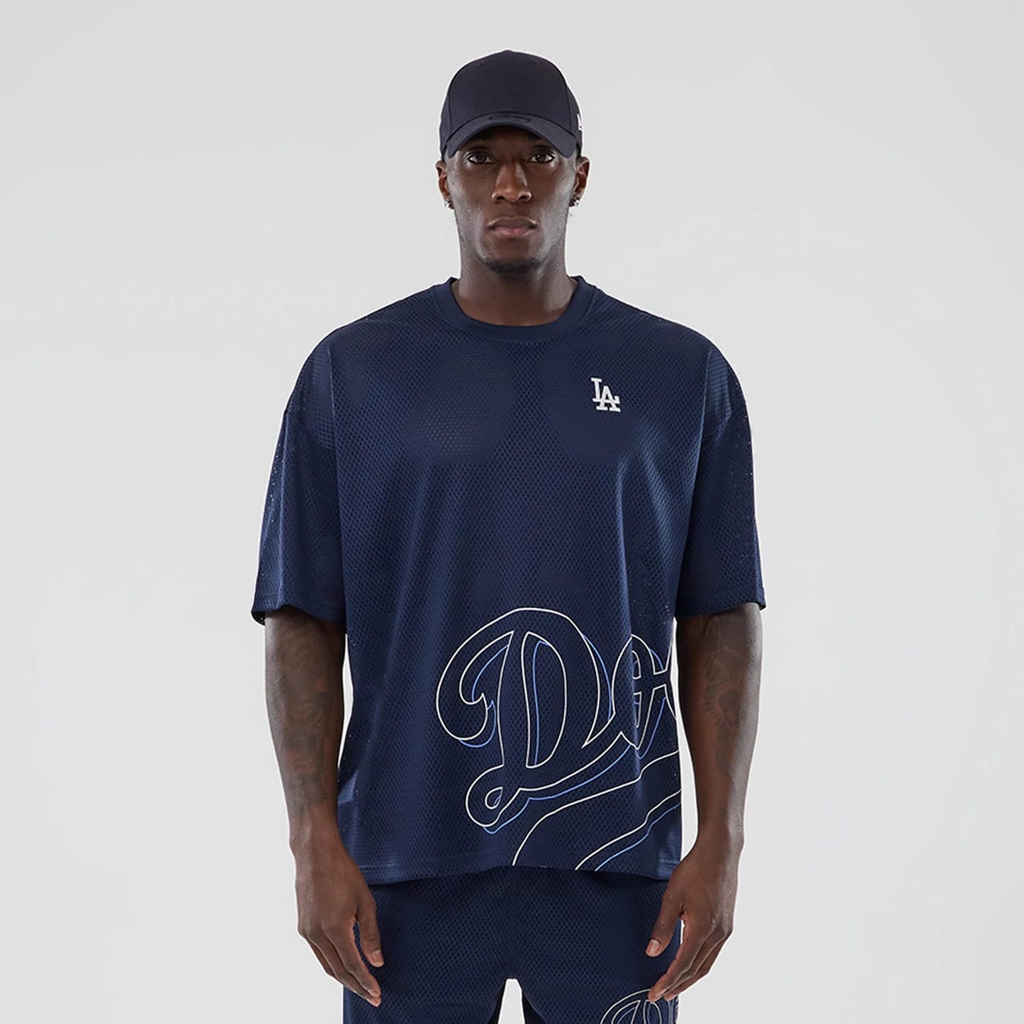 The model is wearing this MLB Mix League LA Dodgers Oversized Mesh T-Shirt in blue. 1