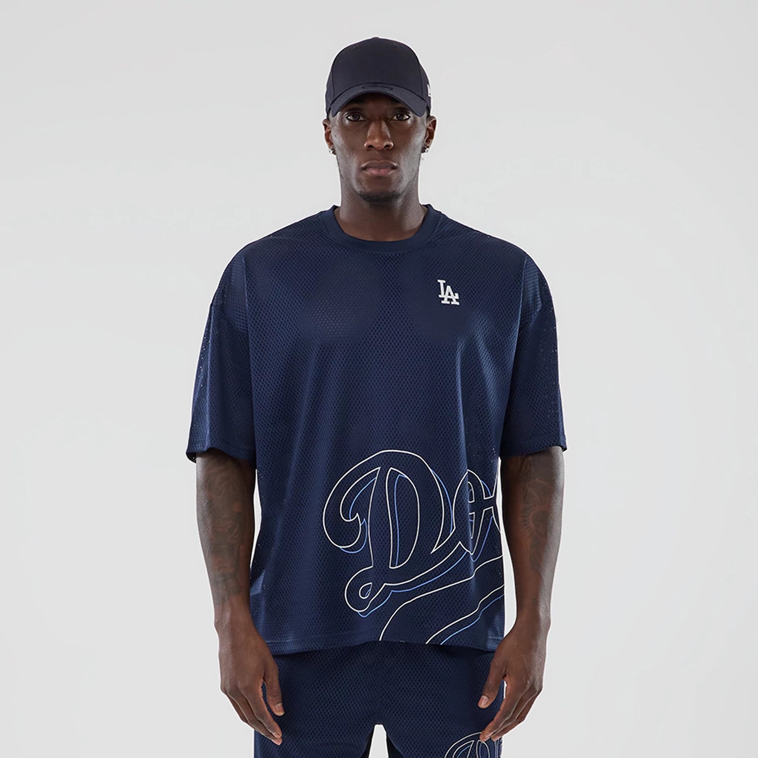 The model is wearing this MLB Mix League LA Dodgers Oversized Mesh T-Shirt in blue. 1