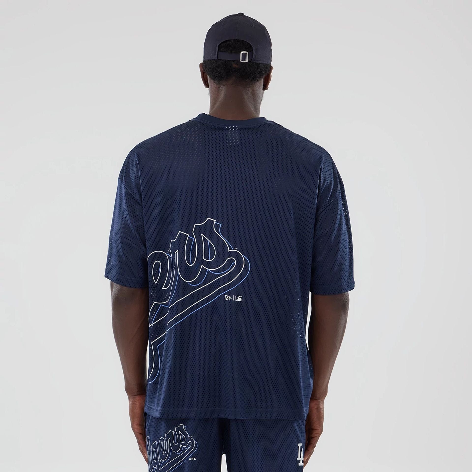 The model is wearing this MLB Mix League LA Dodgers Oversized Mesh T-Shirt in blue. 2