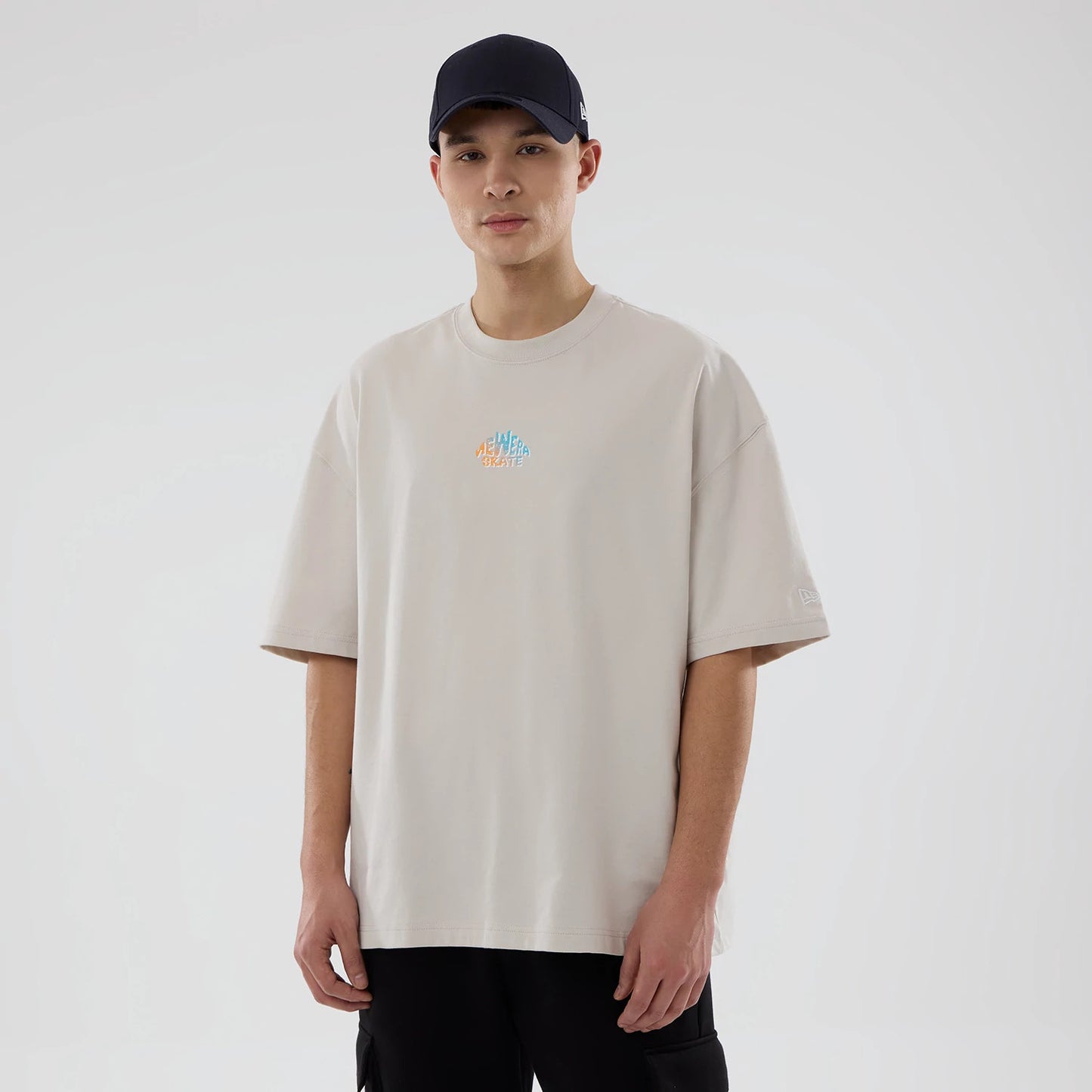 The model is wearing this New Era Skate Is Life Graphic Oversized T-Shirt in Cream. 1