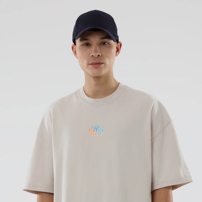 The model is wearing this New Era Skate Is Life Graphic Oversized T-Shirt in Cream. 6