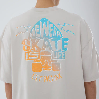The model is wearing this New Era Skate Is Life Graphic Oversized T-Shirt in Cream. 4