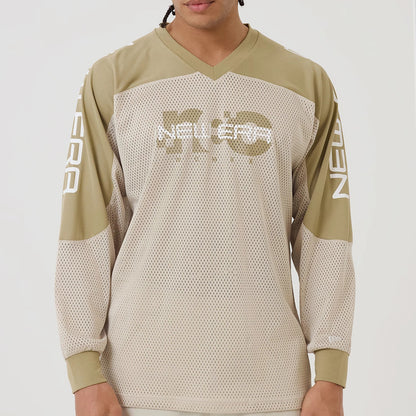 The model is wearing this New Era NEC Logo Long Sleeve Jersey in beige/khaki. 8