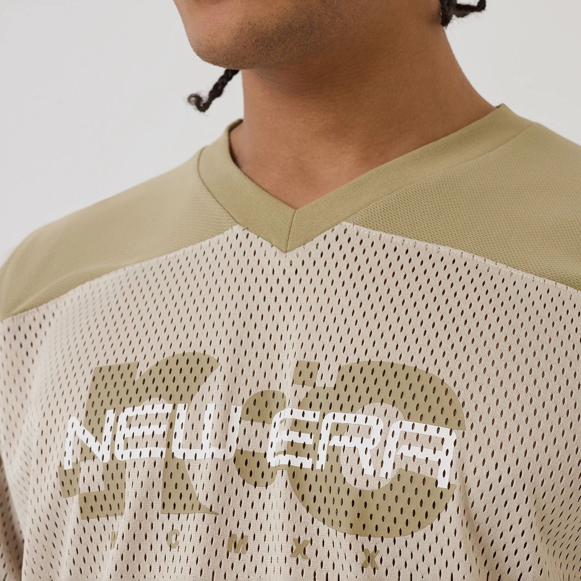 The model is wearing this New Era Urban Core Long Sleeve Jersey in beige/khaki. 5
